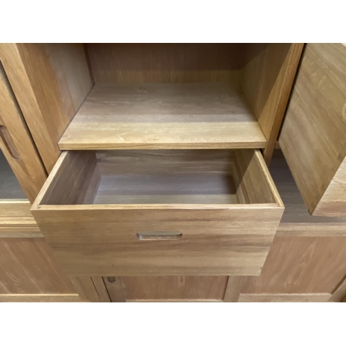 27 - A Laura Ashley Milton oak compartmental storage system - approx. 129cm high x 221cm wide x 40cm deep