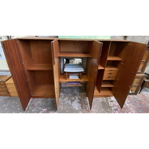 37 - A mid 20th century G Plan Fresco teak wardrobe system - approx. 214cm high x 304cm wide x 56cm deep