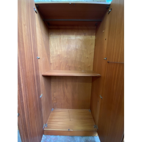 37 - A mid 20th century G Plan Fresco teak wardrobe system - approx. 214cm high x 304cm wide x 56cm deep