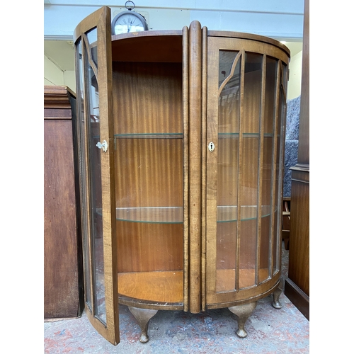 42 - An Art Deco style walnut bow fronted display cabinet - approx. 126cm high x 100cm wide x 34cm deep