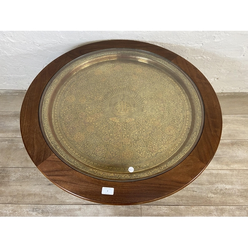 7 - A mid 20th century G Plan Astro teak and glass circular coffee table with inset Indian etched brass ... 