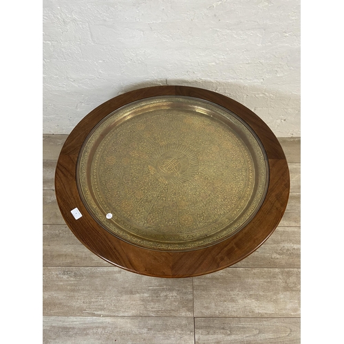 7 - A mid 20th century G Plan Astro teak and glass circular coffee table with inset Indian etched brass ... 