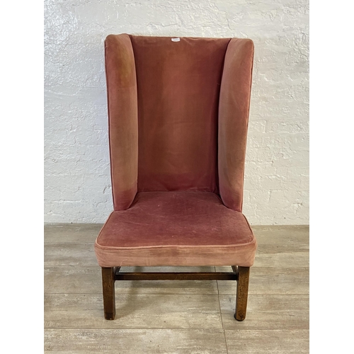 72C - A late 19th/early 20th century pink fabric upholstered high back porter's chair on mahogany supports... 