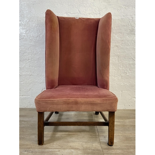 72C - A late 19th/early 20th century pink fabric upholstered high back porter's chair on mahogany supports... 