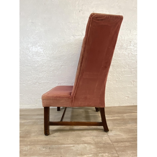 72C - A late 19th/early 20th century pink fabric upholstered high back porter's chair on mahogany supports... 