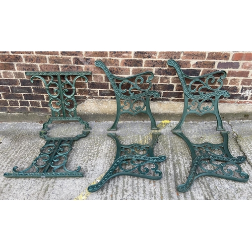 75 - Six green painted cast iron outdoor furniture accessories, two table legs and four bench ends