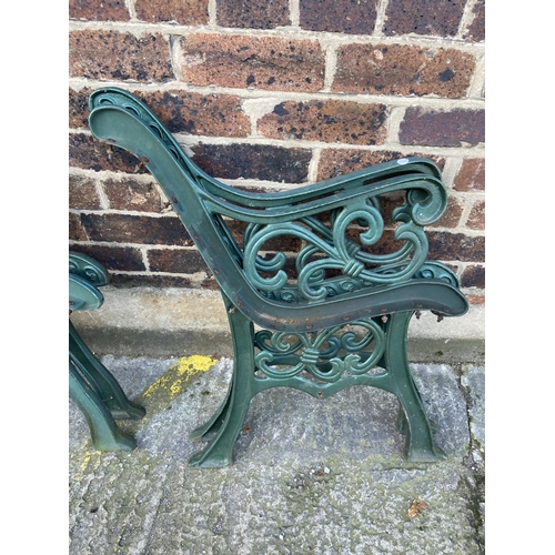 75 - Six green painted cast iron outdoor furniture accessories, two table legs and four bench ends