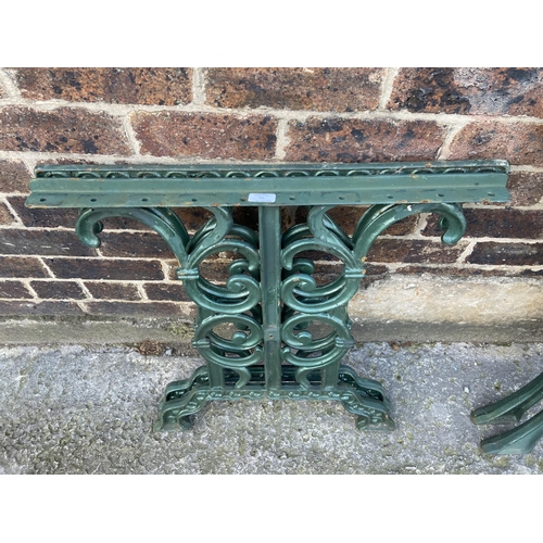 75 - Six green painted cast iron outdoor furniture accessories, two table legs and four bench ends