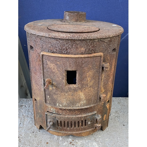 76 - Three outdoor items, one cast iron stove and two Victorian style lanterns