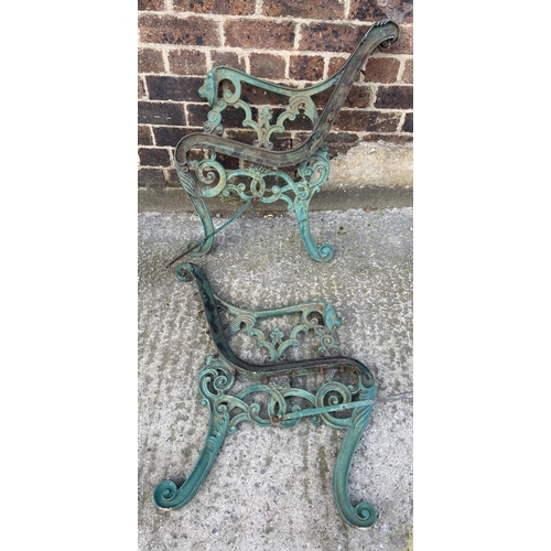 77 - A pair of green painted cast iron garden bench ends