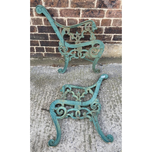 77 - A pair of green painted cast iron garden bench ends