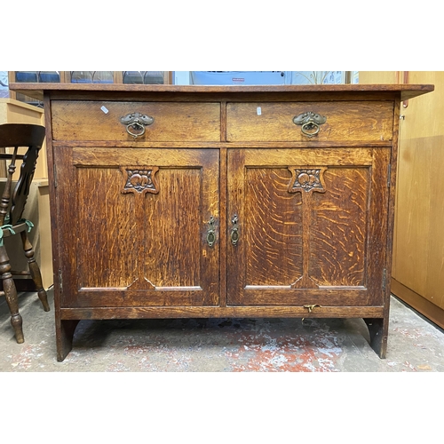 88 - An Arts & Crafts carved oak sideboard - approx. 97cm high x 137cm wide x 57cm deep