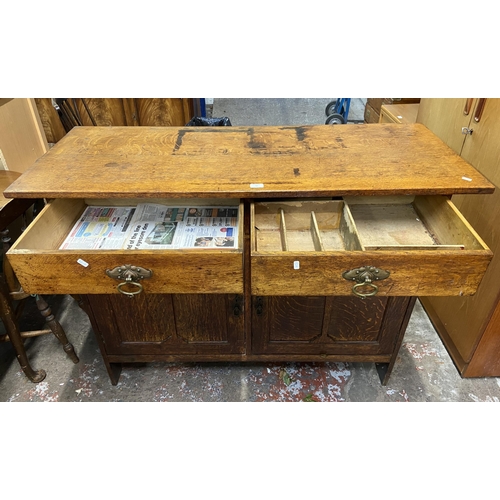 88 - An Arts & Crafts carved oak sideboard - approx. 97cm high x 137cm wide x 57cm deep