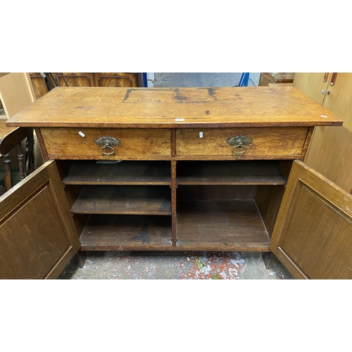 88 - An Arts & Crafts carved oak sideboard - approx. 97cm high x 137cm wide x 57cm deep