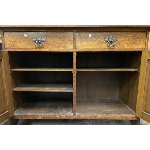 88 - An Arts & Crafts carved oak sideboard - approx. 97cm high x 137cm wide x 57cm deep