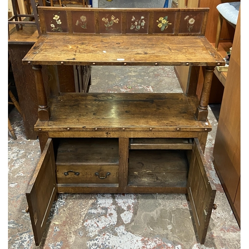 89 - A 19th century oak buffet with hand painted floral design back - approx. 126cm high x 110cm wide x 4... 