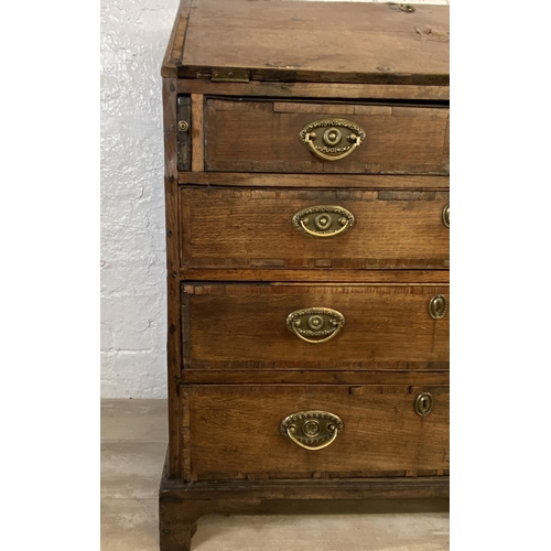 90 - A George III mahogany crossbanded and oak bureau - approx. 98cm high x 87cm wide x 46cm deep