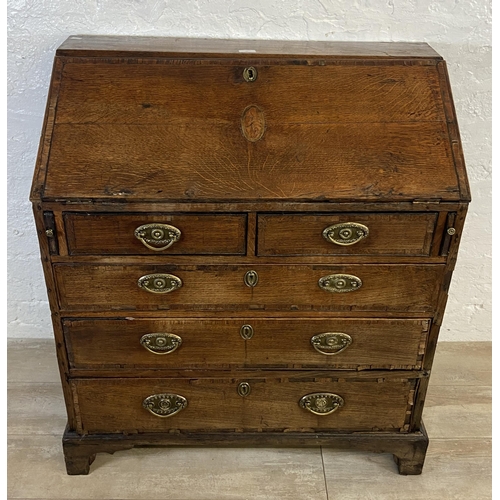 90 - A George III mahogany crossbanded and oak bureau - approx. 98cm high x 87cm wide x 46cm deep