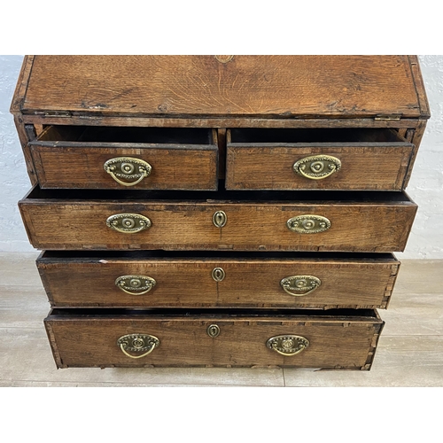 90 - A George III mahogany crossbanded and oak bureau - approx. 98cm high x 87cm wide x 46cm deep