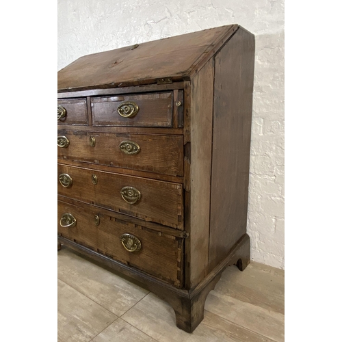 90 - A George III mahogany crossbanded and oak bureau - approx. 98cm high x 87cm wide x 46cm deep