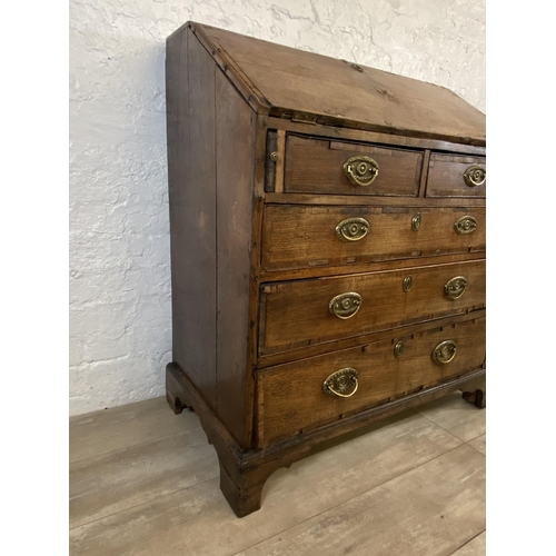 90 - A George III mahogany crossbanded and oak bureau - approx. 98cm high x 87cm wide x 46cm deep