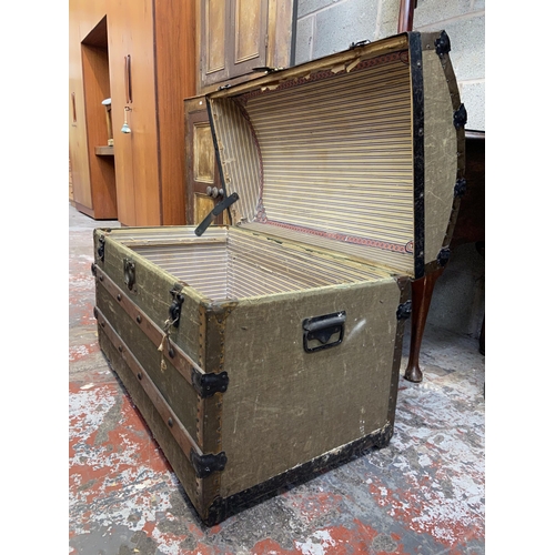 98 - An early 20th century green canvas and wooden banded dome top travel trunk - approx. 57cm high x 85c... 