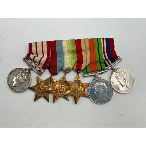 2361 - A collection of WWII British militaria, six piece medal group presented to Schlmr. J. F. Davidson. R... 