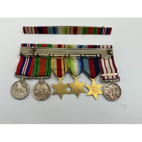 2361 - A collection of WWII British militaria, six piece medal group presented to Schlmr. J. F. Davidson. R... 