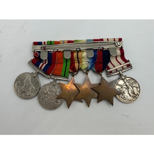 2361 - A collection of WWII British militaria, six piece medal group presented to Schlmr. J. F. Davidson. R... 