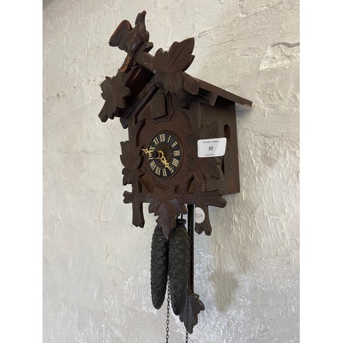 30 - A mid 20th century German carved wooden cased cuckoo clock with two weights - approx. 29cm high