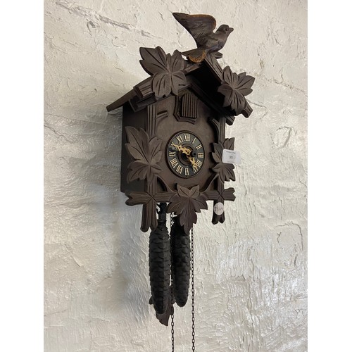 30 - A mid 20th century German carved wooden cased cuckoo clock with two weights - approx. 29cm high