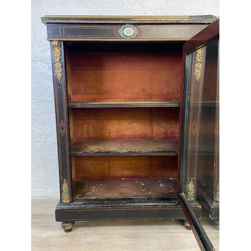 31 - A pair of 19th century ebonised and inlaid pier cabinets with gilt metal decoration and hand painted... 