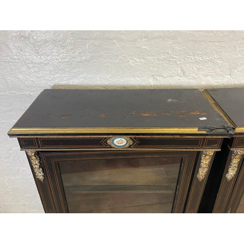 31 - A pair of 19th century ebonised and inlaid pier cabinets with gilt metal decoration and hand painted... 