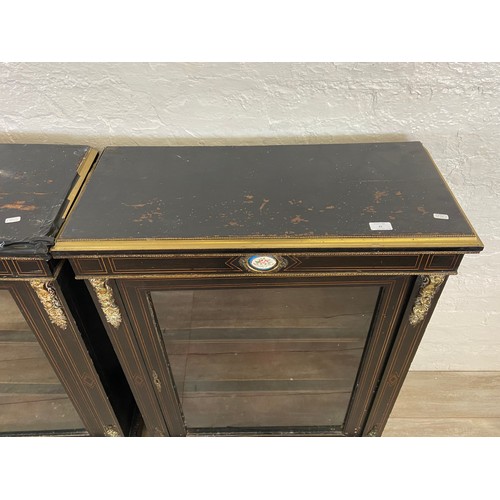 31 - A pair of 19th century ebonised and inlaid pier cabinets with gilt metal decoration and hand painted... 