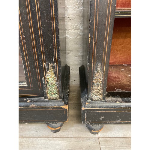 31 - A pair of 19th century ebonised and inlaid pier cabinets with gilt metal decoration and hand painted... 