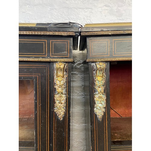 31 - A pair of 19th century ebonised and inlaid pier cabinets with gilt metal decoration and hand painted... 