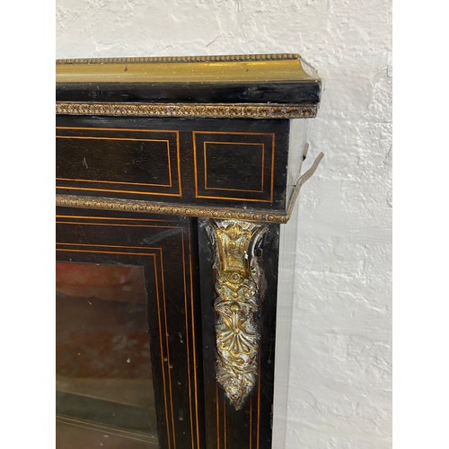 31 - A pair of 19th century ebonised and inlaid pier cabinets with gilt metal decoration and hand painted... 