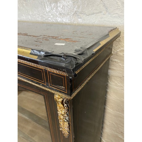 31 - A pair of 19th century ebonised and inlaid pier cabinets with gilt metal decoration and hand painted... 