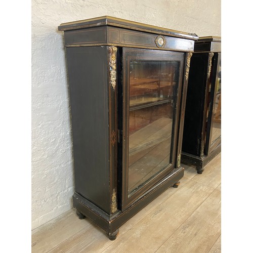 31 - A pair of 19th century ebonised and inlaid pier cabinets with gilt metal decoration and hand painted... 