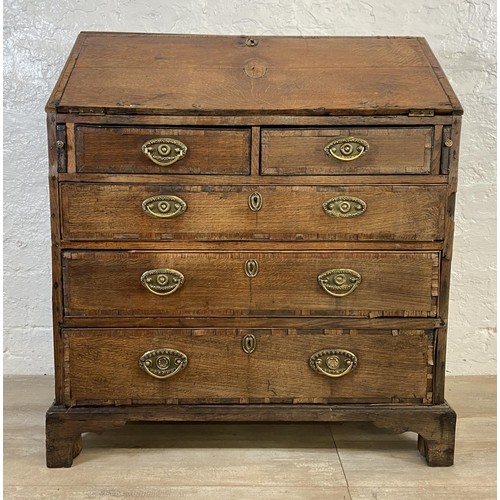 90 - A George III mahogany crossbanded and oak bureau - approx. 98cm high x 87cm wide x 46cm deep