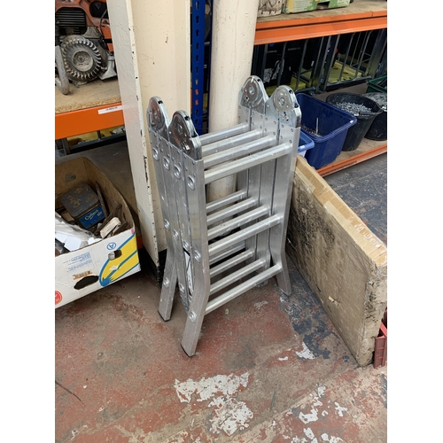 1040 - Two pairs of aluminium ladders, one step and one work platform together with a boxed fire guard