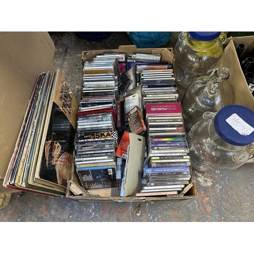 1084 - A collection of house clearance items to include DVDs, walking cane, ceramics, glassware etc.