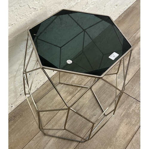 10 - A contemporary black glass and metal hexagonal side table - approx. 51cm high x 41 cm wide x 35cm de... 