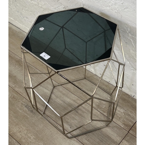 10 - A contemporary black glass and metal hexagonal side table - approx. 51cm high x 41 cm wide x 35cm de... 