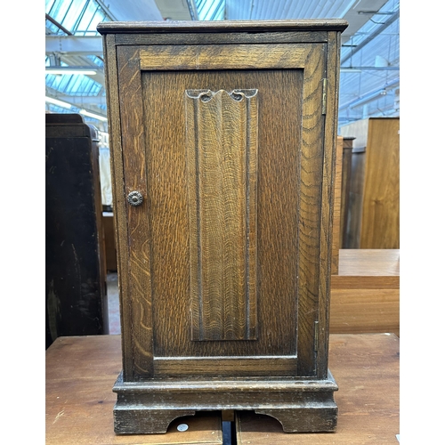 101 - A carved oak linenfold bedside cabinet - approx. 67cm high x 37cm wide x 65cm deep