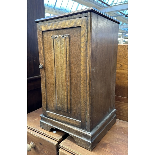 101 - A carved oak linenfold bedside cabinet - approx. 67cm high x 37cm wide x 65cm deep