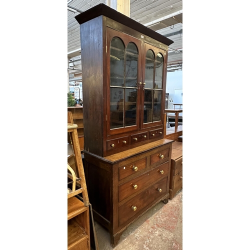 103 - An early 19th century Welsh mahogany and oak bookcase - approx. 215cm high x 110cm wide x 47cm deep