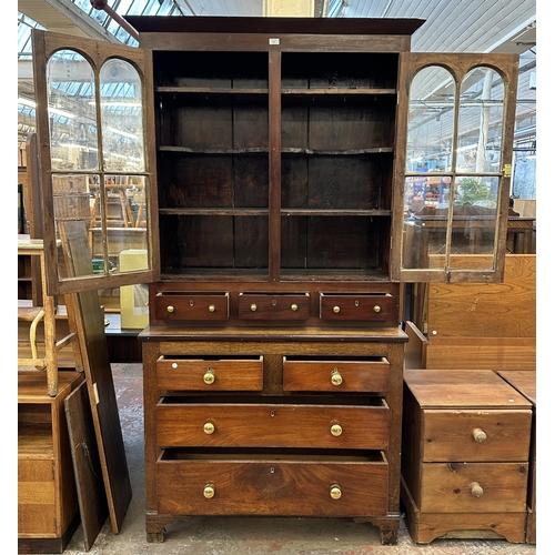 103 - An early 19th century Welsh mahogany and oak bookcase - approx. 215cm high x 110cm wide x 47cm deep