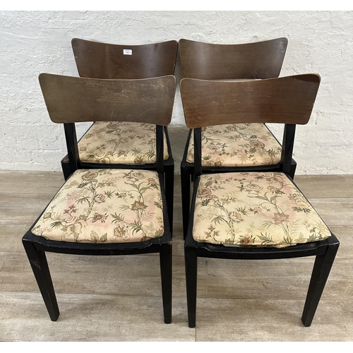 110 - Four mid 20th century teak and ebonised dining chairs with floral fabric upholstery