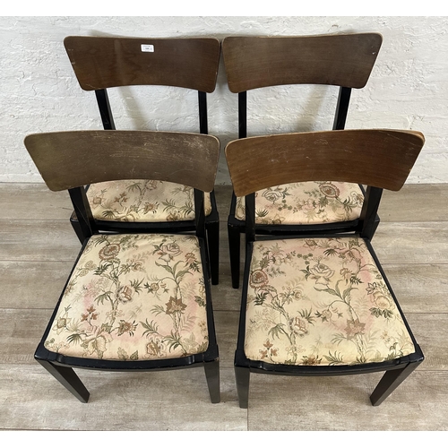 110 - Four mid 20th century teak and ebonised dining chairs with floral fabric upholstery